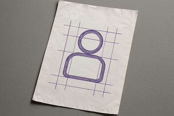 A photograph of a slightly worn, wrinkled blank sheet of white paper that lays flat, slightly tilted, on a table. On the paper is an icon of a human figure.